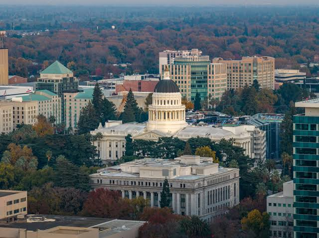 California State Capitol dome surrounded by fall trees in downtown Sacramento